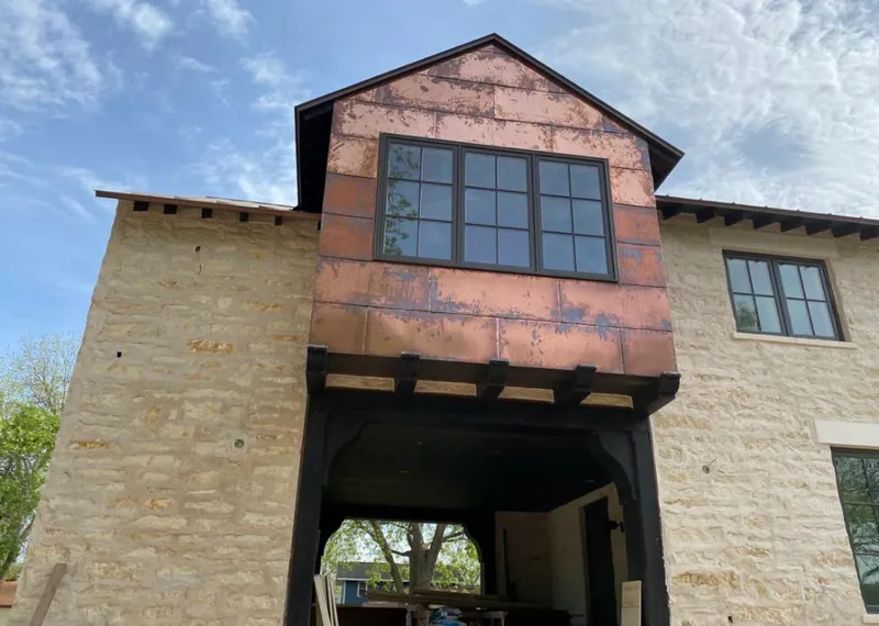 Copper metal panel facade on a stone building for Skylight Installation in Land O' Lakes