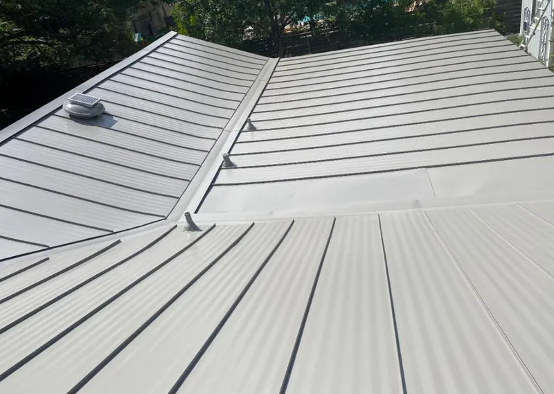 Solar attic fan installed on a metal roof for Roof Ventilation in Land O' Lakes